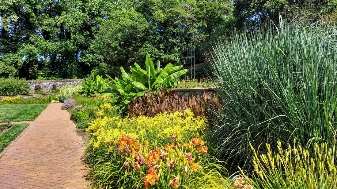 A brick path through colourful flower beds in Biltmore's Walled Garden