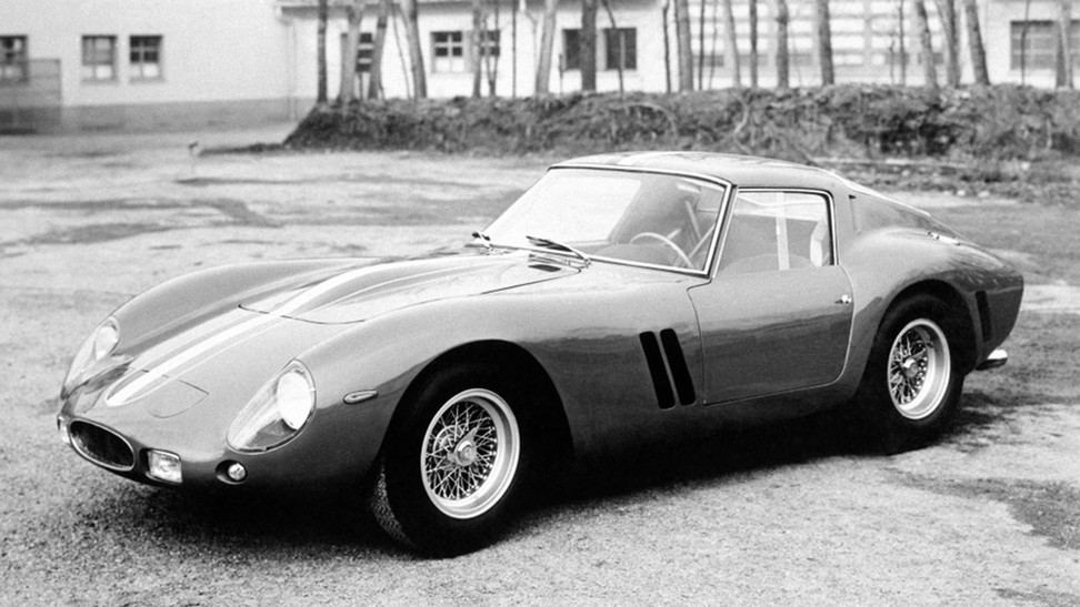A black and white photograph of a Ferrari 250 GTO in 1962
