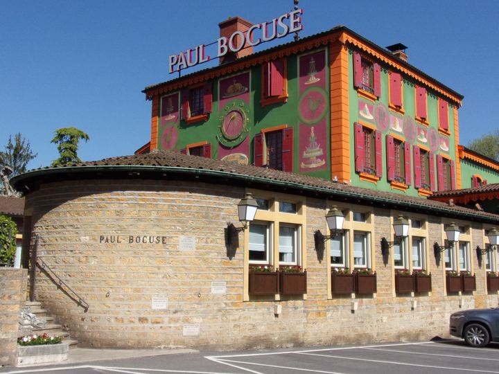 The brightly painted red and green facade of L'Auberge du Pont de Collonges, the restaurant of Paul Bocuse